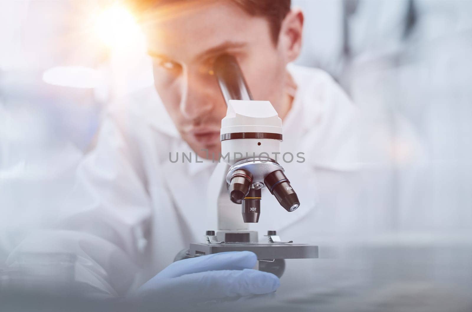 Scientist looks through a microscope in a laboratory. research concept