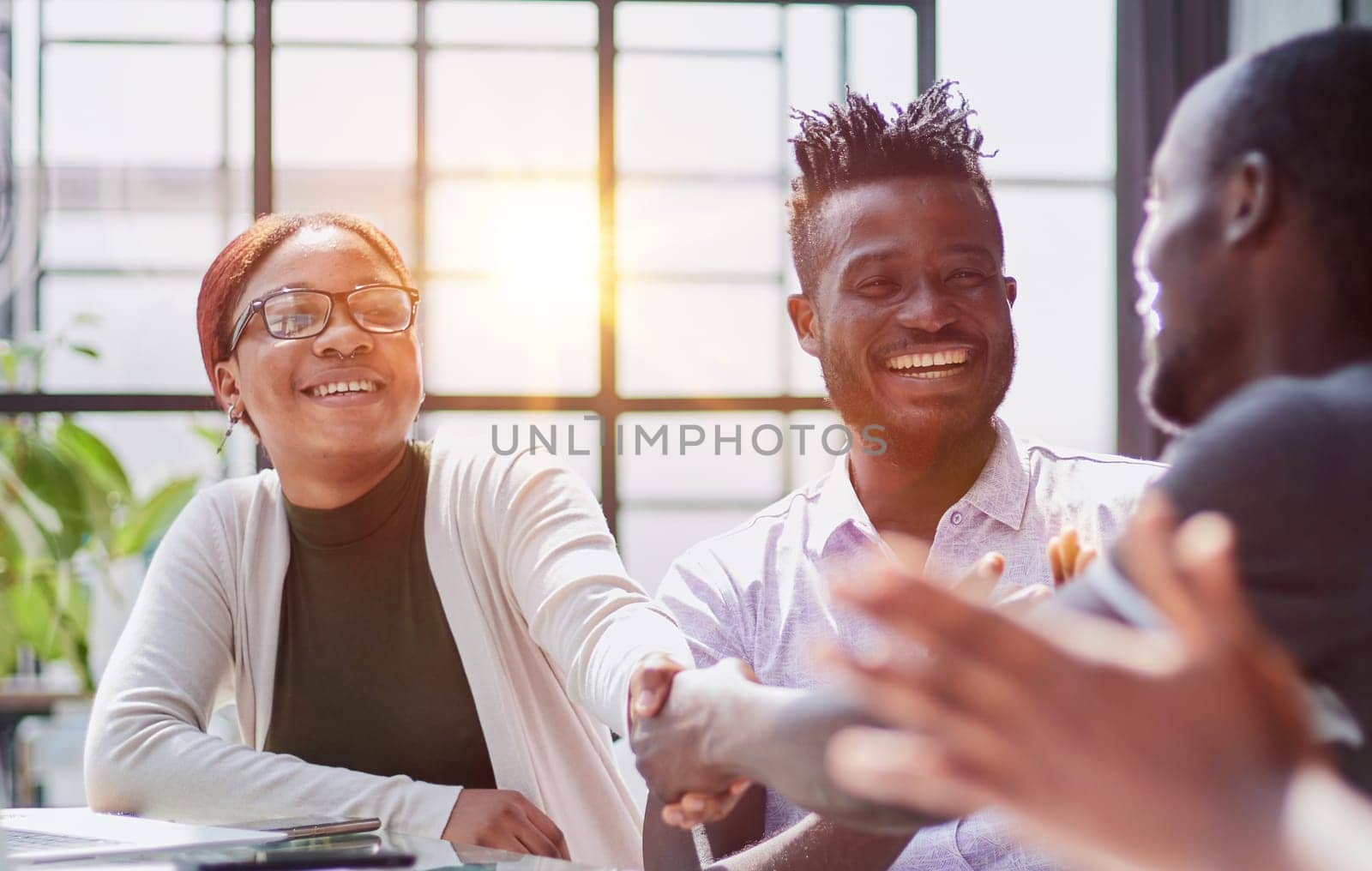 african business people handshake at modern office by Prosto