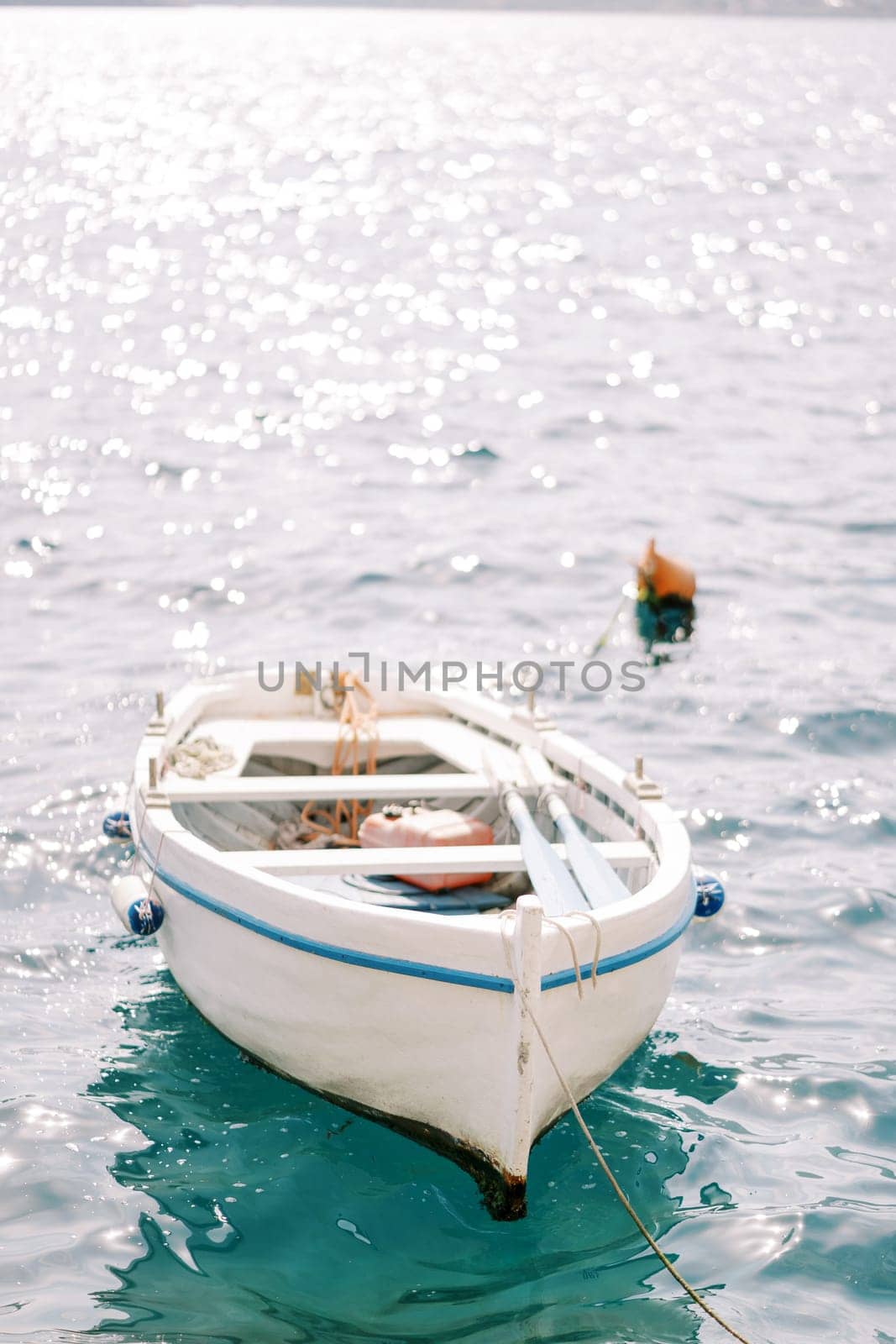 White fishing boat moored in the sea. High quality photo