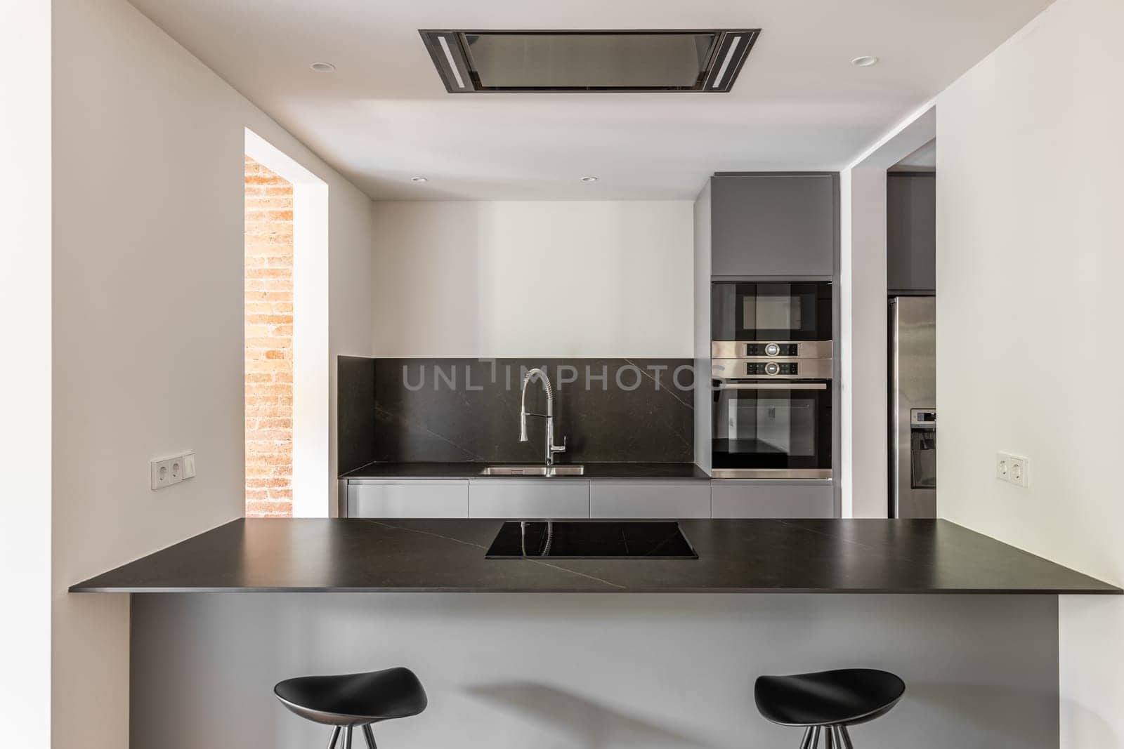 Modern renovated kitchen with dining island and bar stools by apavlin