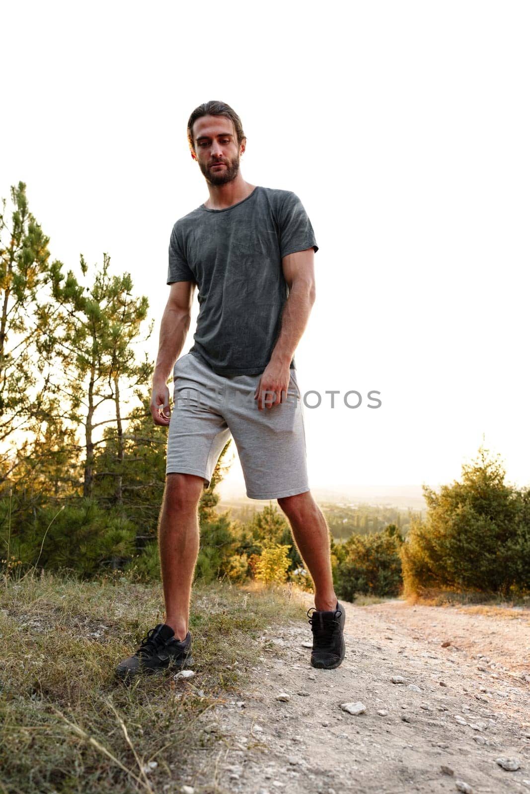 Casual man hiker outdoors in gray T-shirt outdoors portrait close up