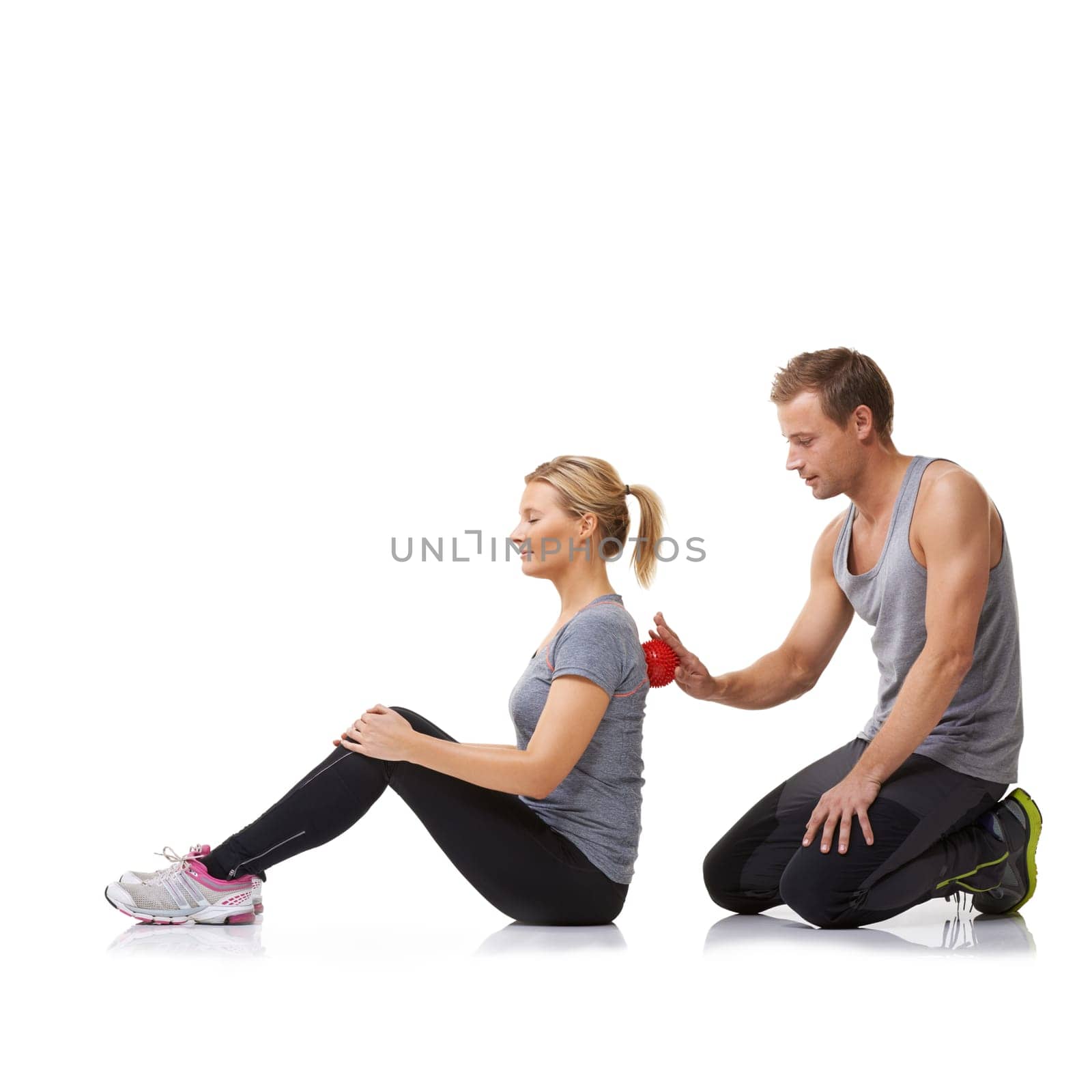 Massage ball, physiotherapy and studio with a woman with sport, fitness and workout back injury. Physical therapy, man and wellness with physio health and helping with white background and support.