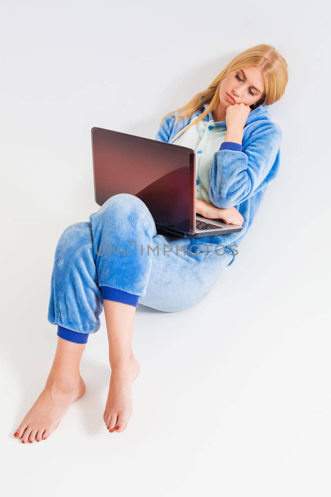 girl in pajamas with a laptop lying on the floor by nazarovsergey