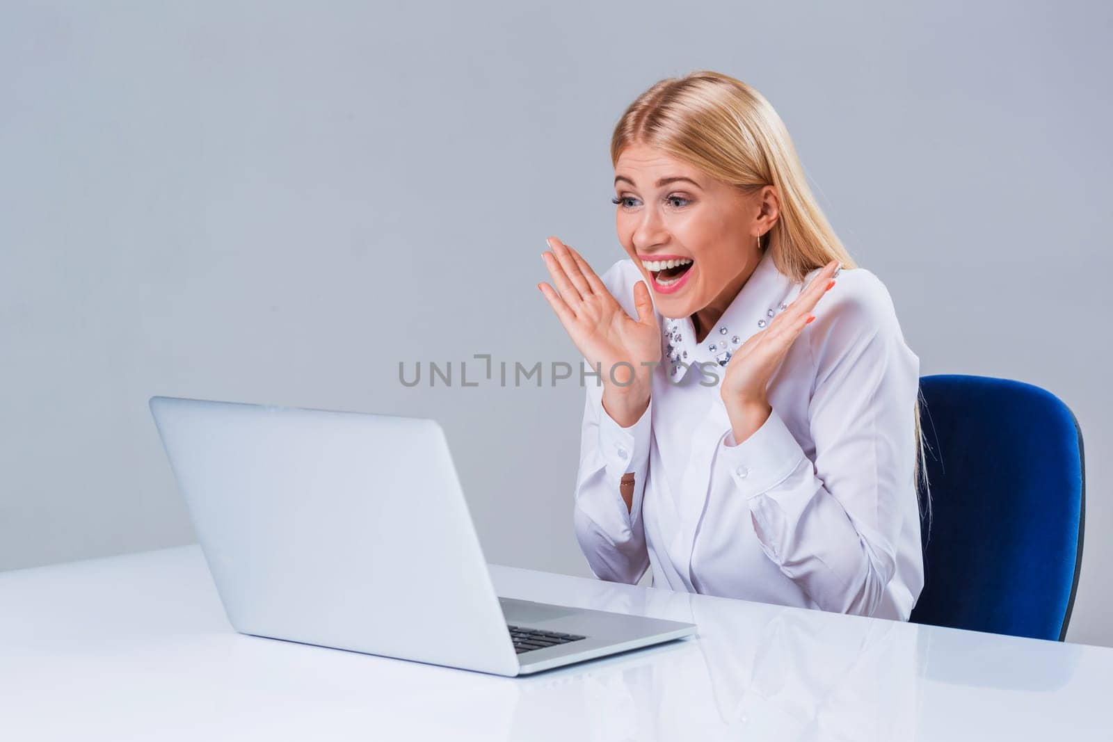 Young businesswoman working at laptop computer. surprised pleased