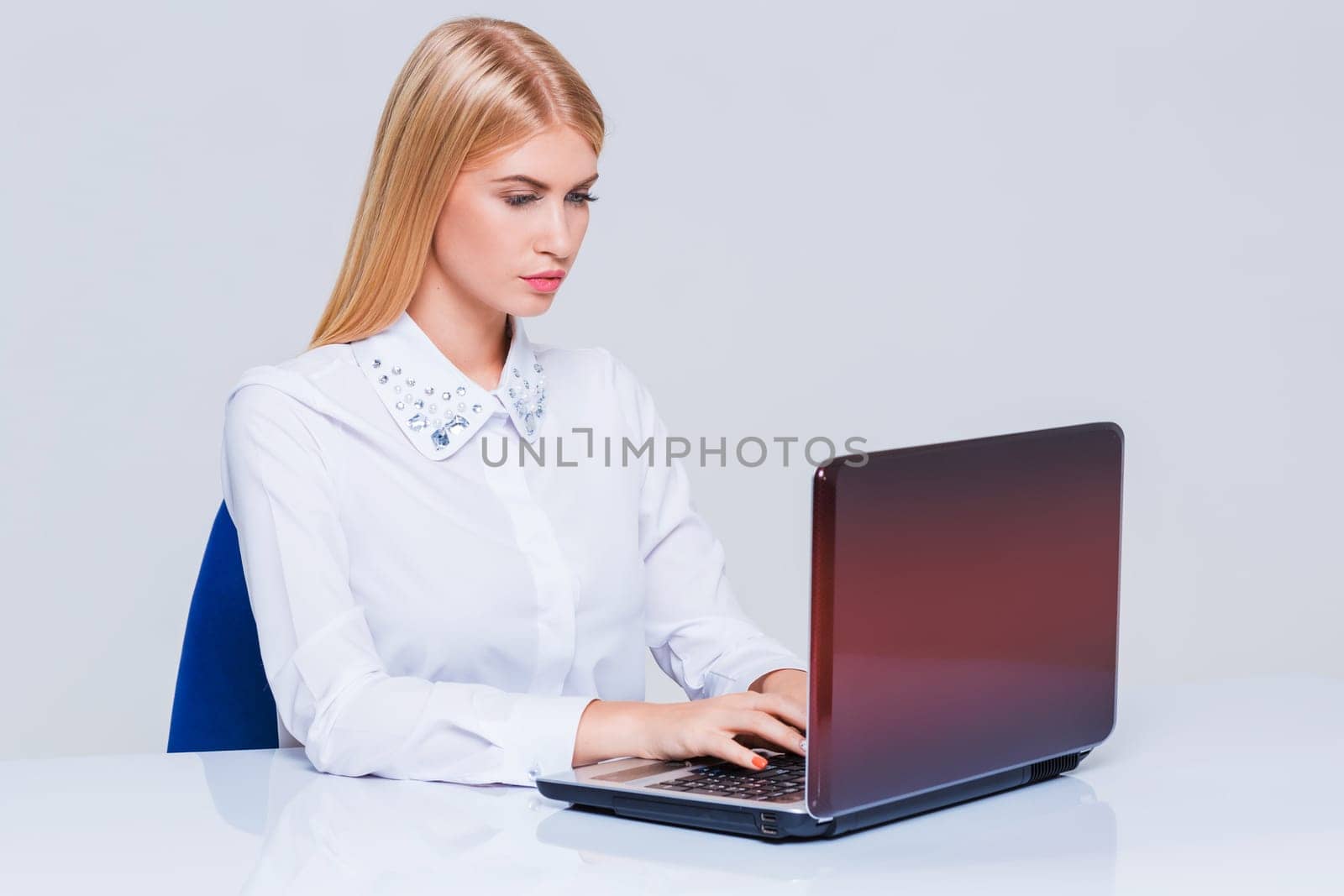 Young businesswoman working at laptop computer. Pretty smiling girl