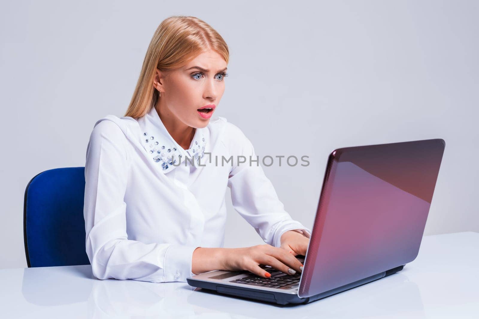 Young businesswoman working at laptop computer. pleasantly surprised dissatisfied girl