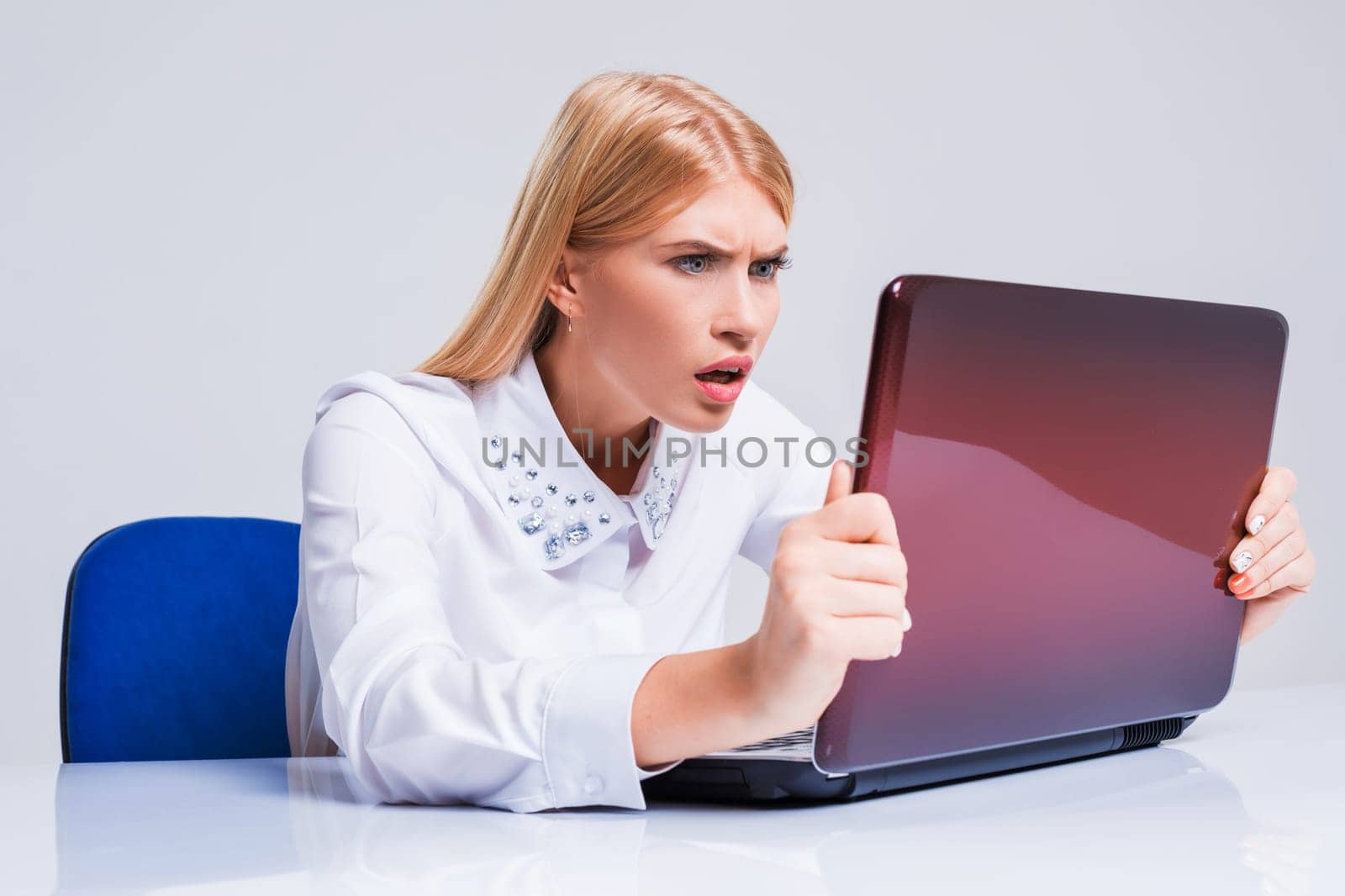Young businesswoman working at laptop computer. pleasantly surprised dissatisfied girl