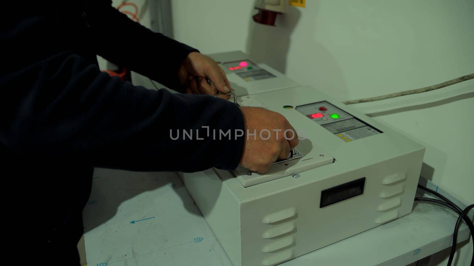 Equipment assembly.Creative.A man with big hands assembles special equipment in a factory. High quality 4k footage