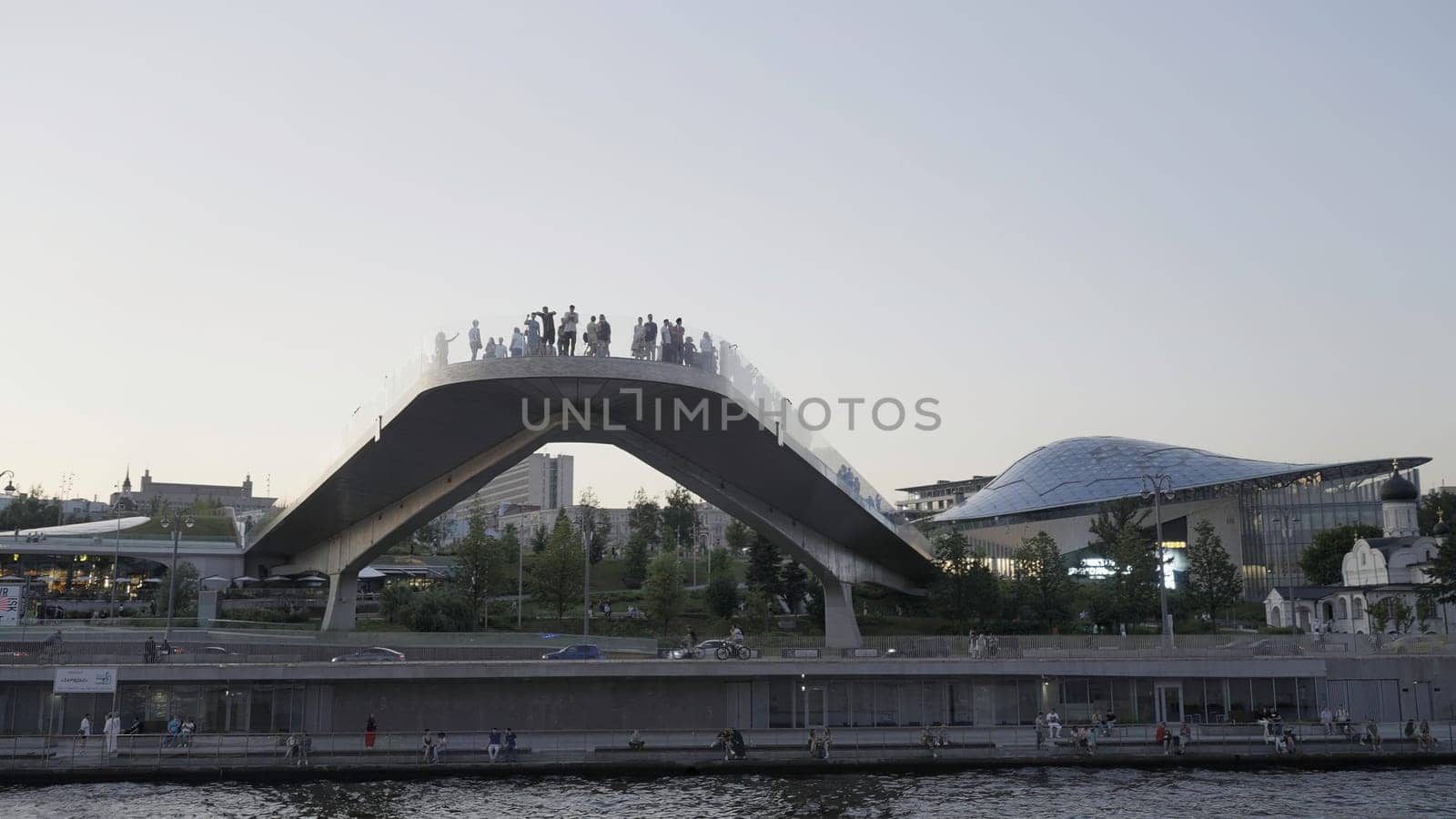 A walk along the river in the city center. Action. Tourist sites are right next to the river that flows next to the tall buildings,churches and shops of the city and walking people are visible. High quality 4k footage