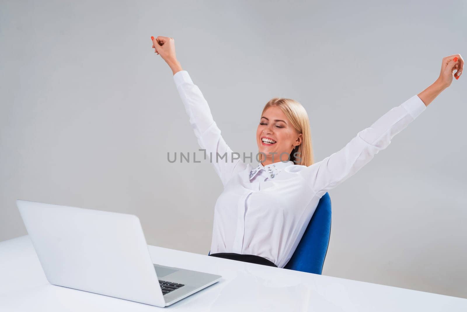 Young businesswoman working at laptop computer. surprised pleased