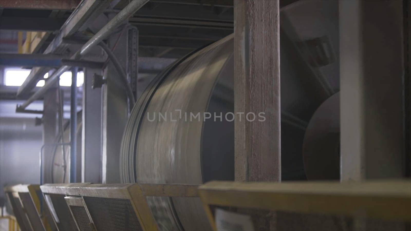 Ore dressing mill or factory grinder at the plant workshop. Rotating machines at the construction materials factory, industrial background.