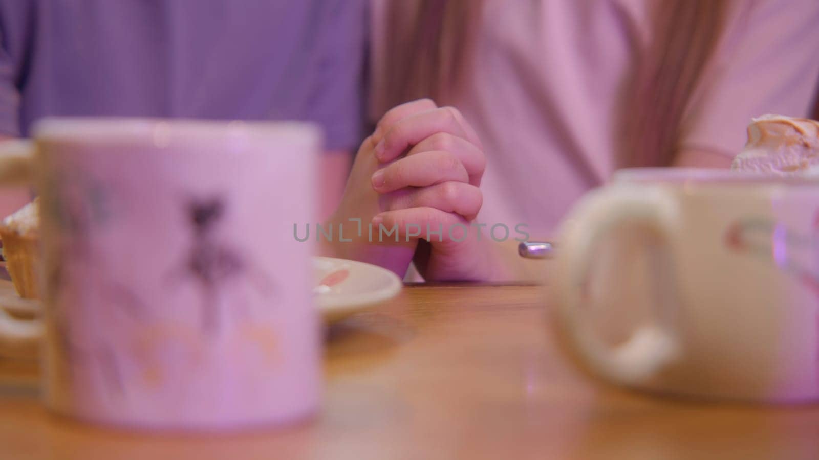 Close-up of children's hands joined together. Stock footage. Children's mugs on background of children's hands. Children's romance and first love.