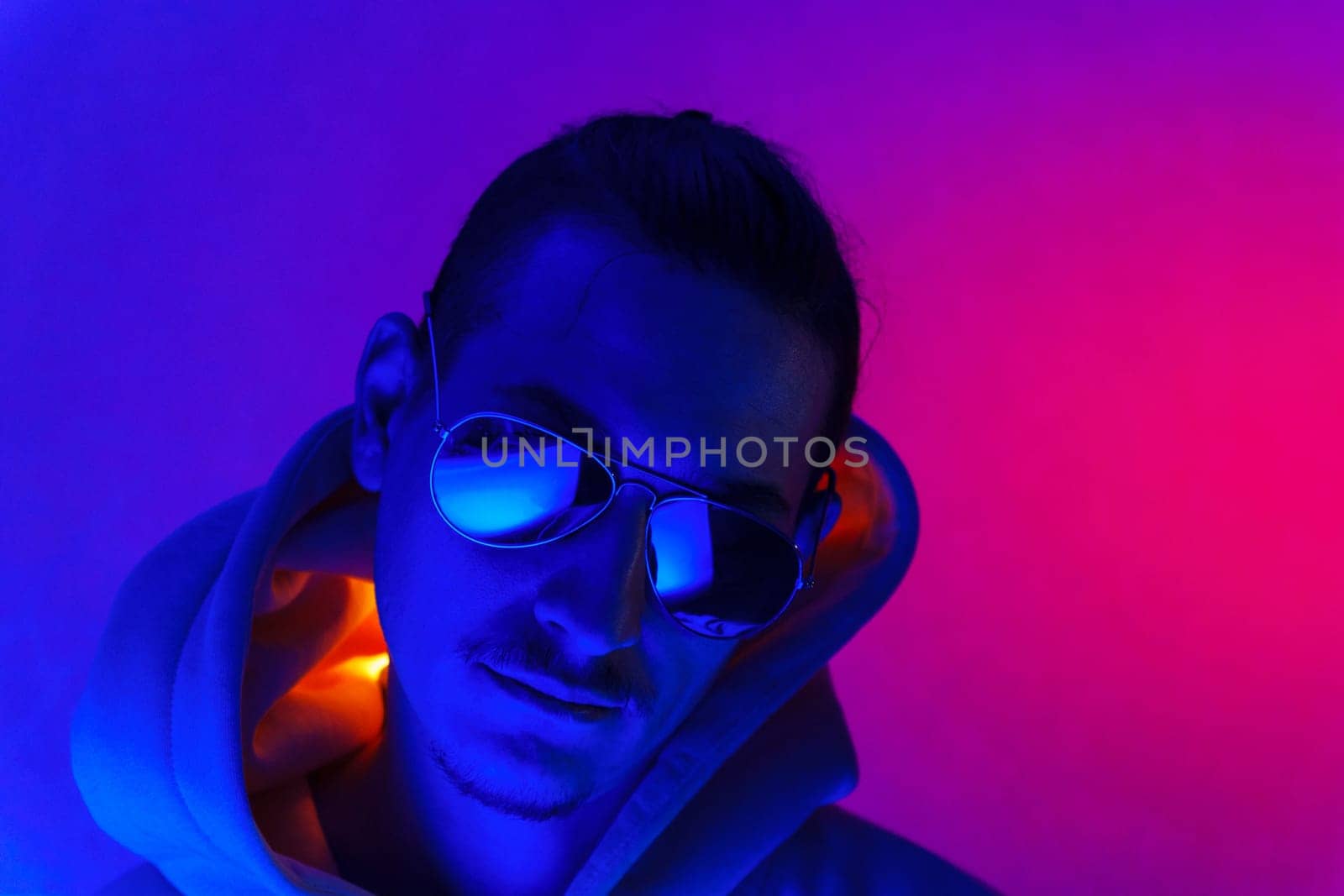 Cool man. Fashionable portrait. Colorful neon light. Stylish confident handsome male in trendy