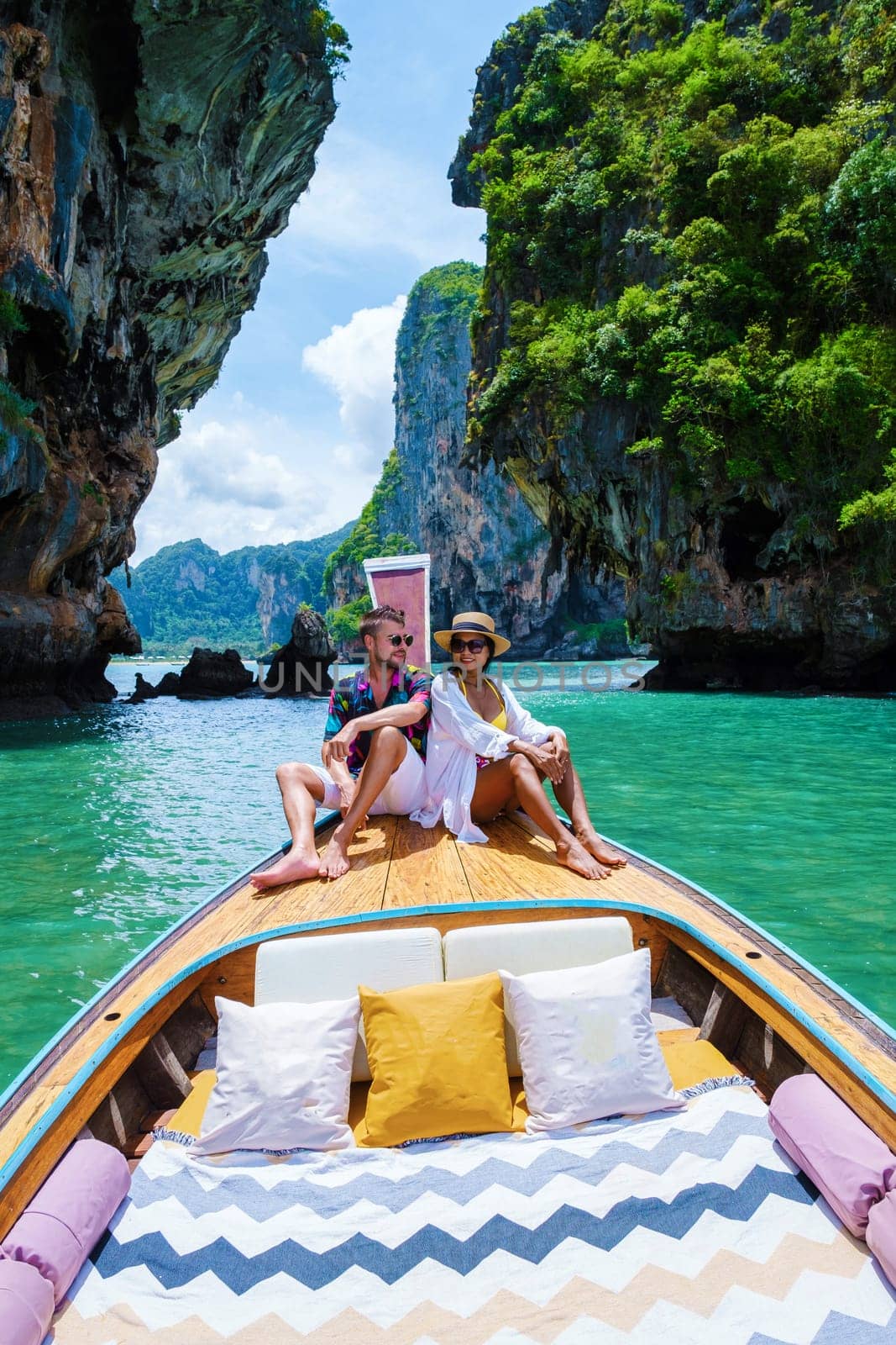 A couple man, and woman on a trip to the tropical island 4 Island trip in Krabi Thailand. Asian woman and European man mid age on vacation in Thailand.