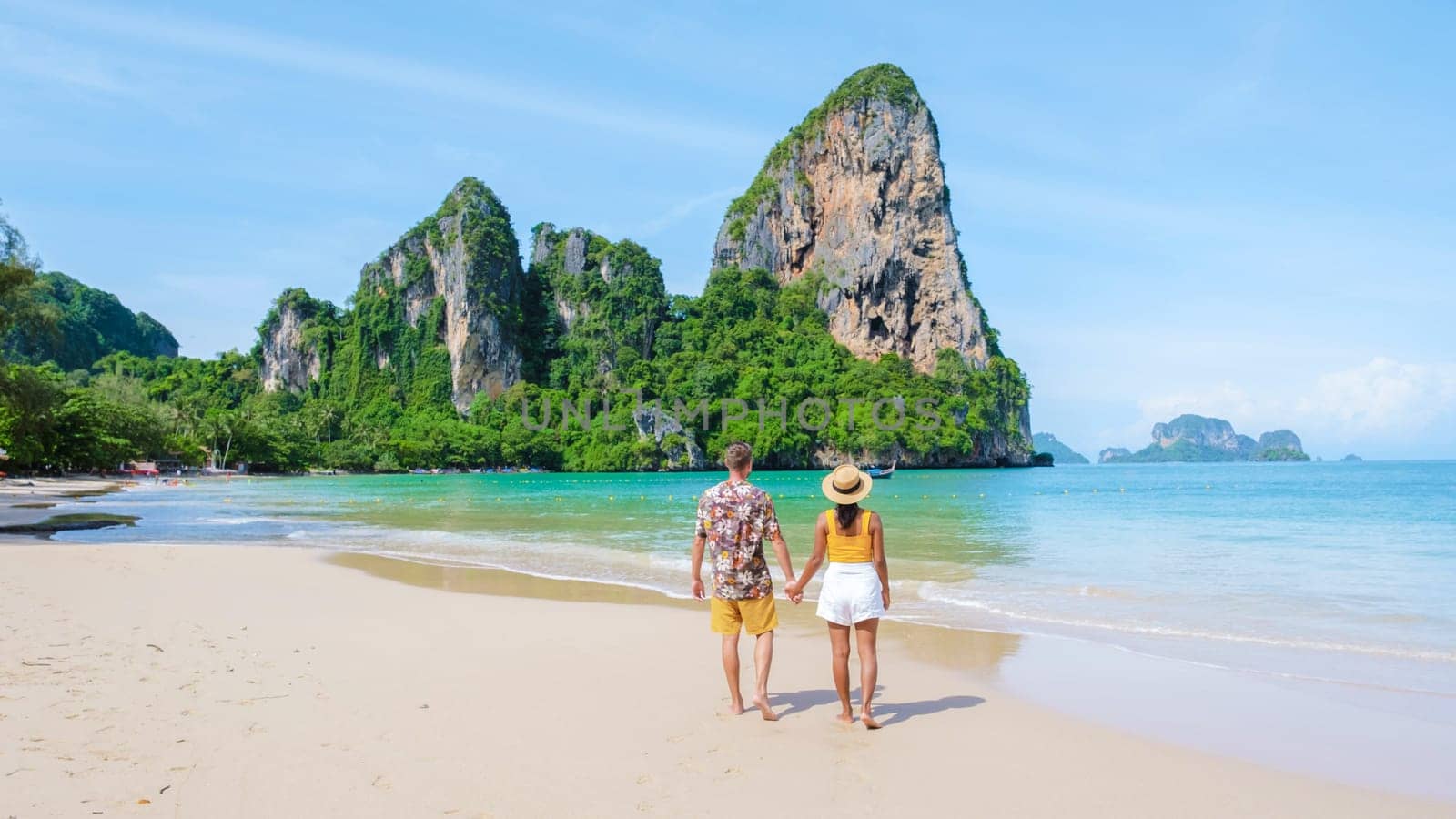 Railay Beach Krabi Thailand, the tropical beach of Railay Krabi, a couple of men and women on the beach, Panoramic view of idyllic Railay Beach in Thailand