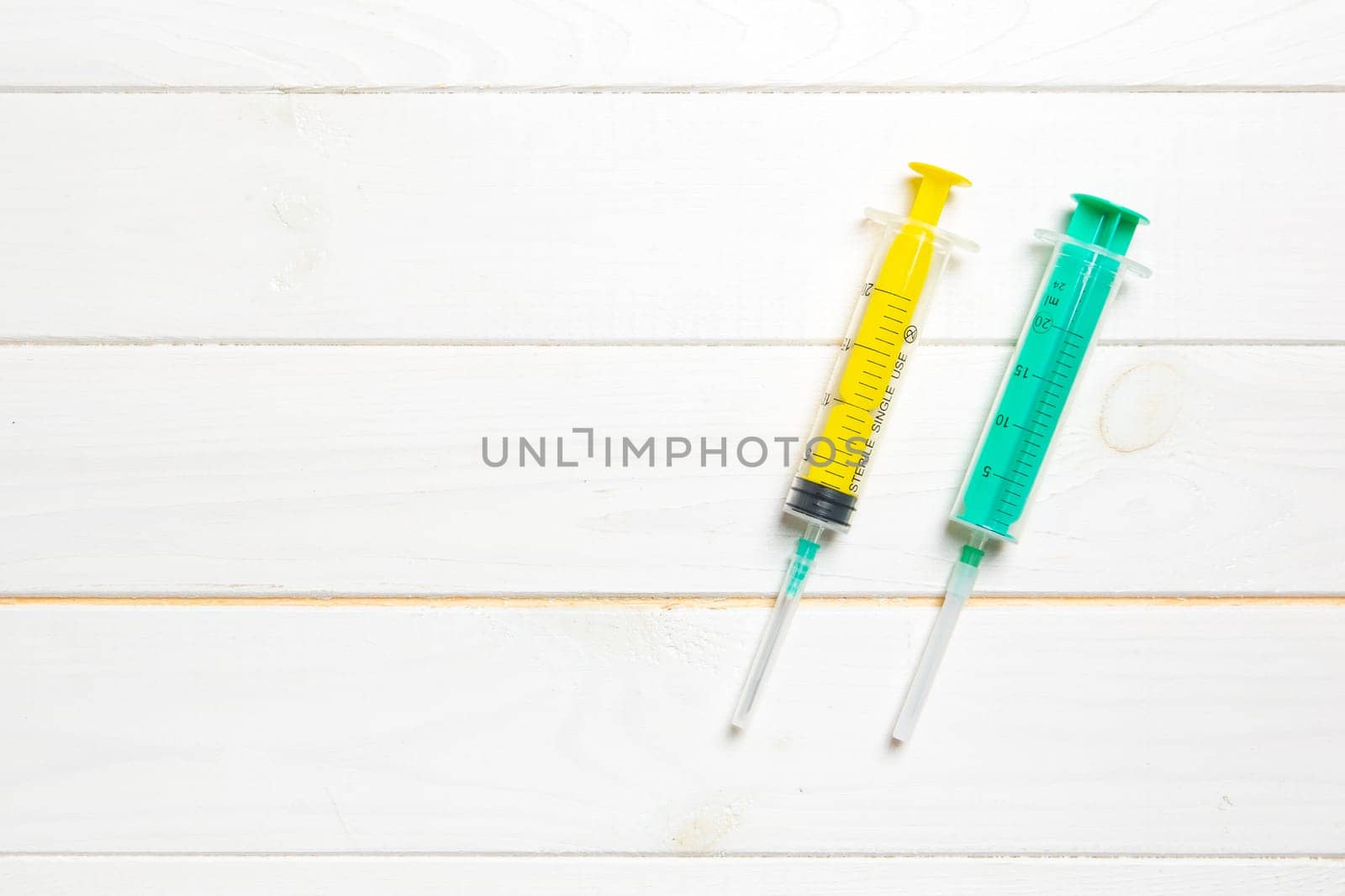 Top view of syringes on wooden background with copy space. Medical equipment for injection concept.