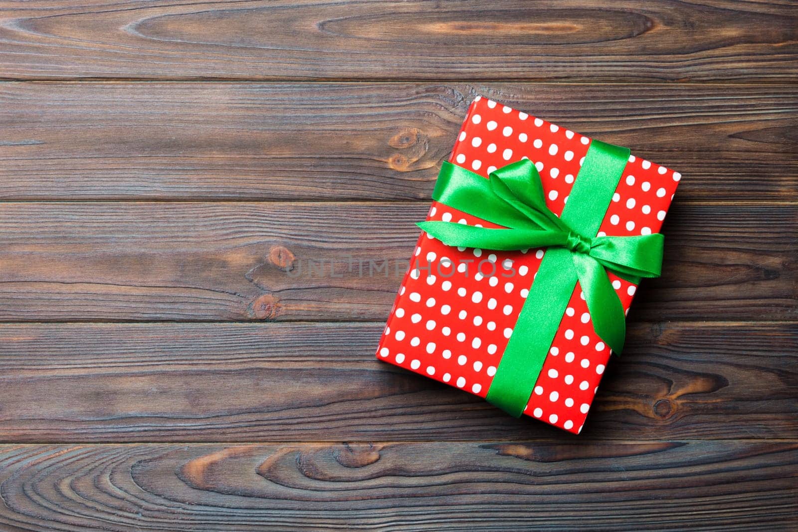 Top view of christmas or other holiday handmade present box package, flat lay dark wooden background with copy space. new year gift box.