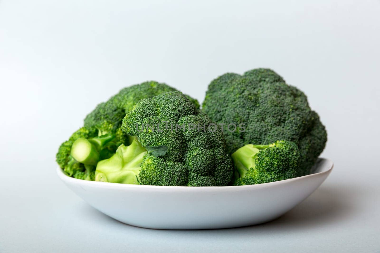 broccoli of fresh green broccoli in bowl over coloredbackground. , close up. Fresh vegetable.