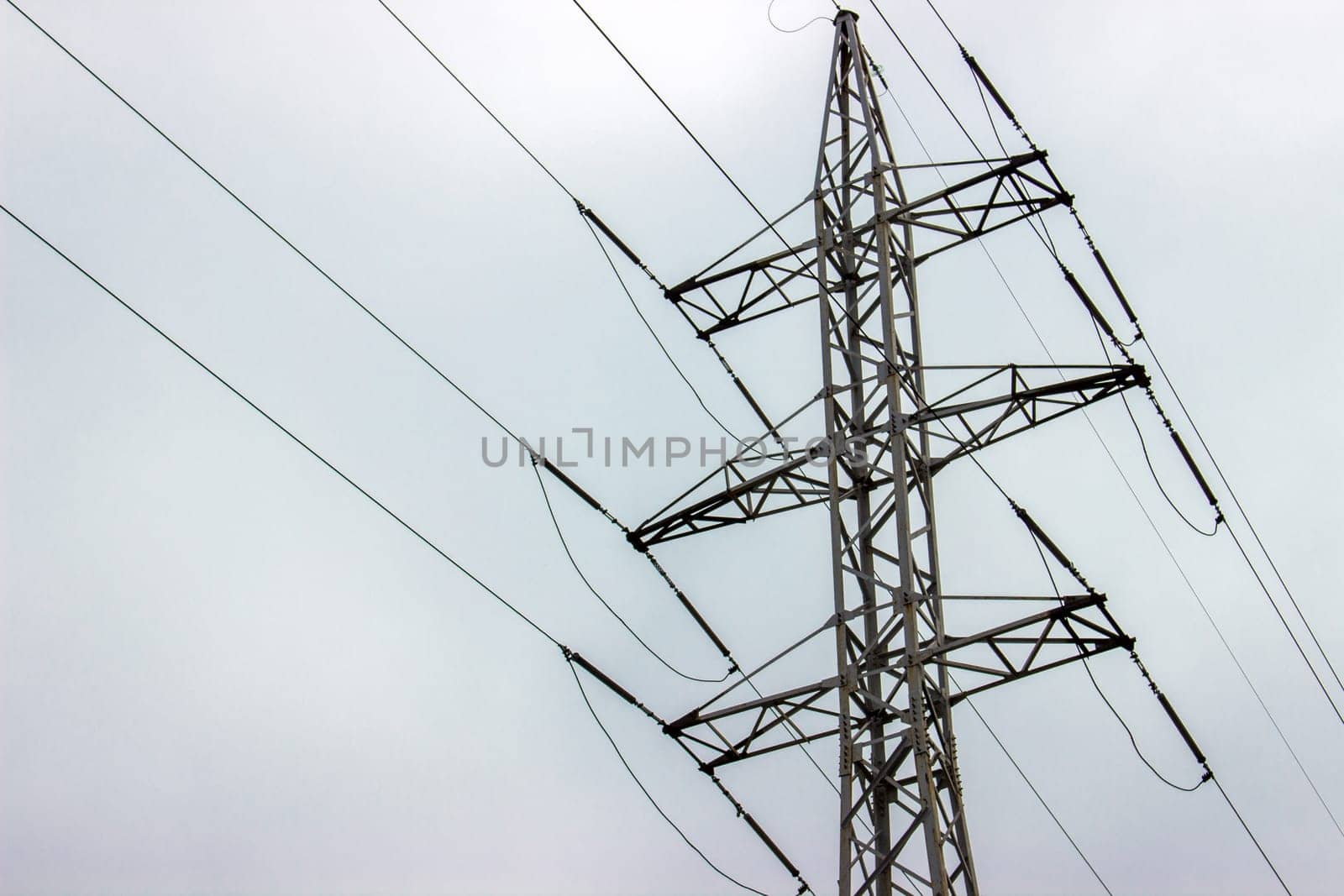 high voltage electrical towers in line. sky background