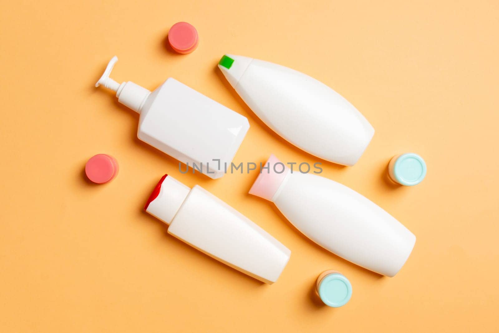 Cosmetics SPA branding mock-up, top view with copy space. set of tubes and jars of cream flat lay on colored background by Snegok1967