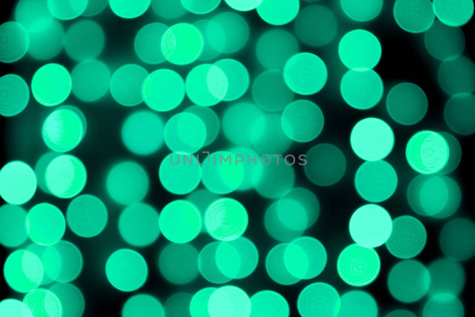 Unfocused abstract colourful bokeh black background. defocused and blurred many round blue light.