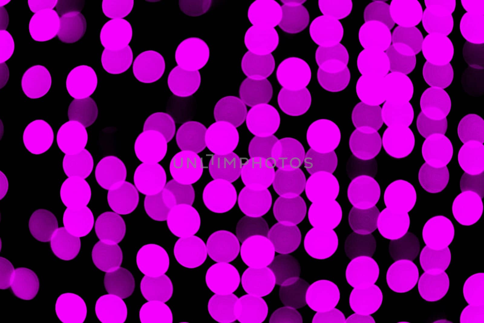 Unfocused abstract pink bokeh on black background. defocused and blurred many round light by Snegok1967