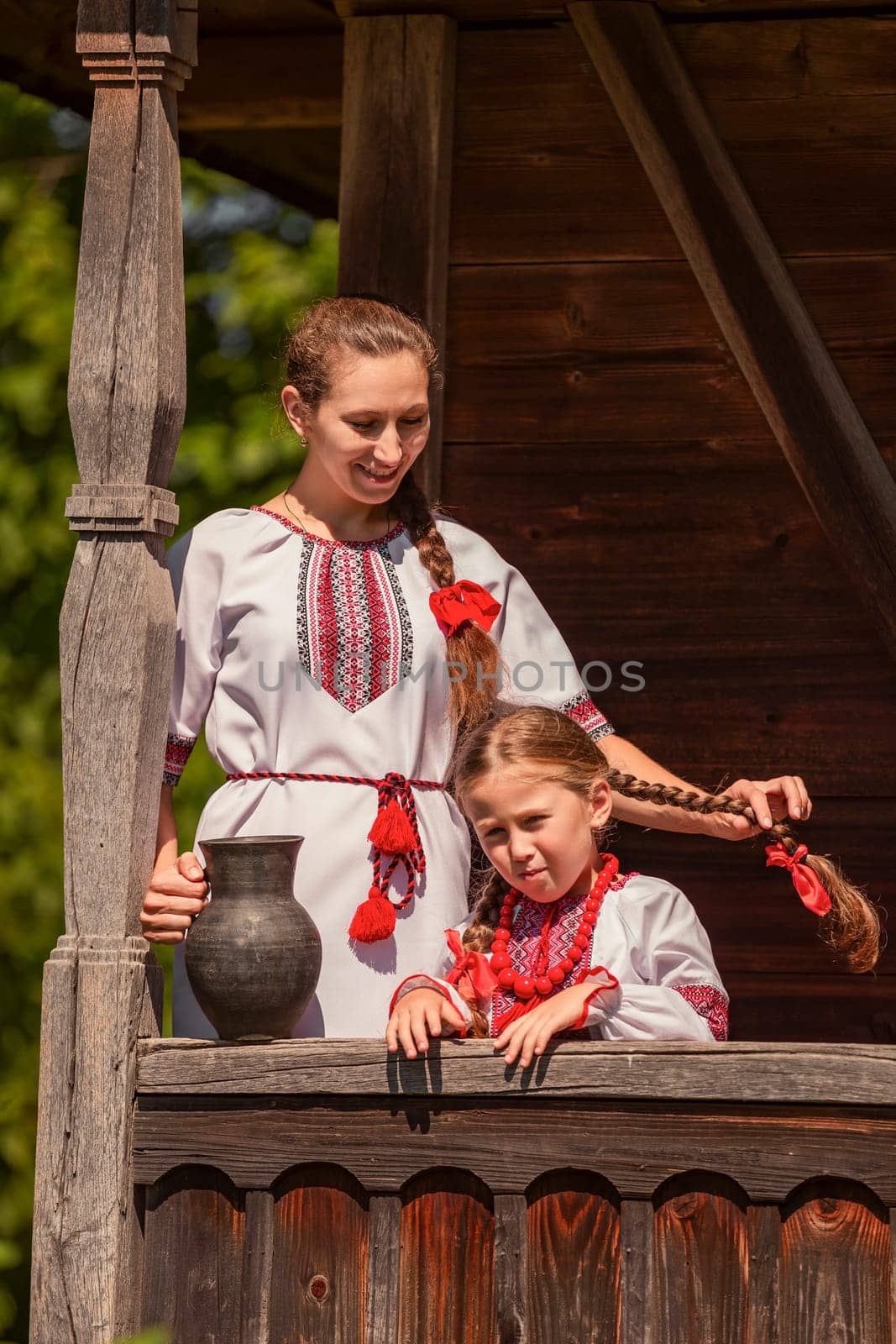 mother with daughter and jug in historical clothes