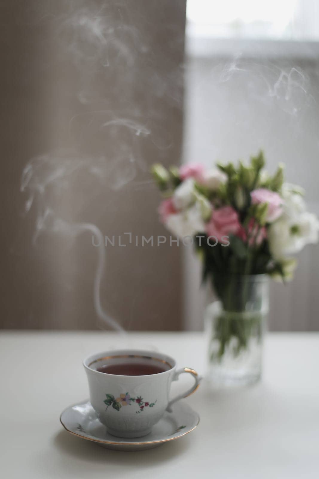 Home still life scene. Cup of coffee or tea with flowers. Vintage feminine styled photo. Floral composition, pink and white roses