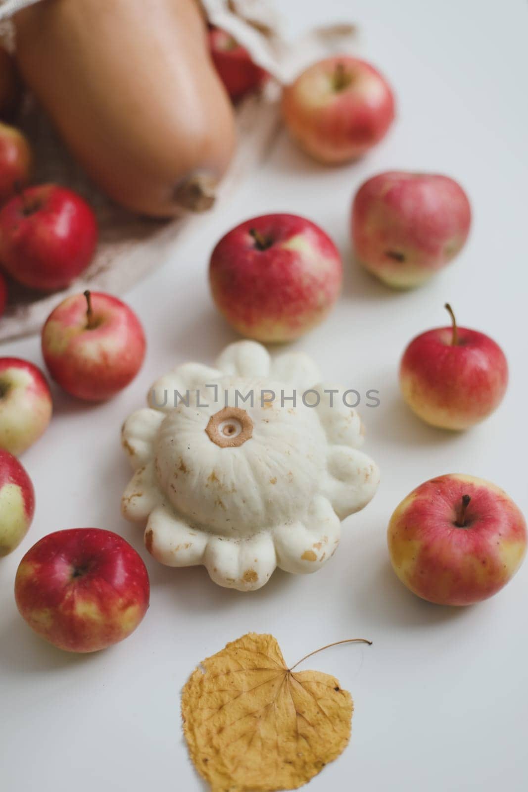 hello autumn card with fresh red apples on white background top view by paralisart