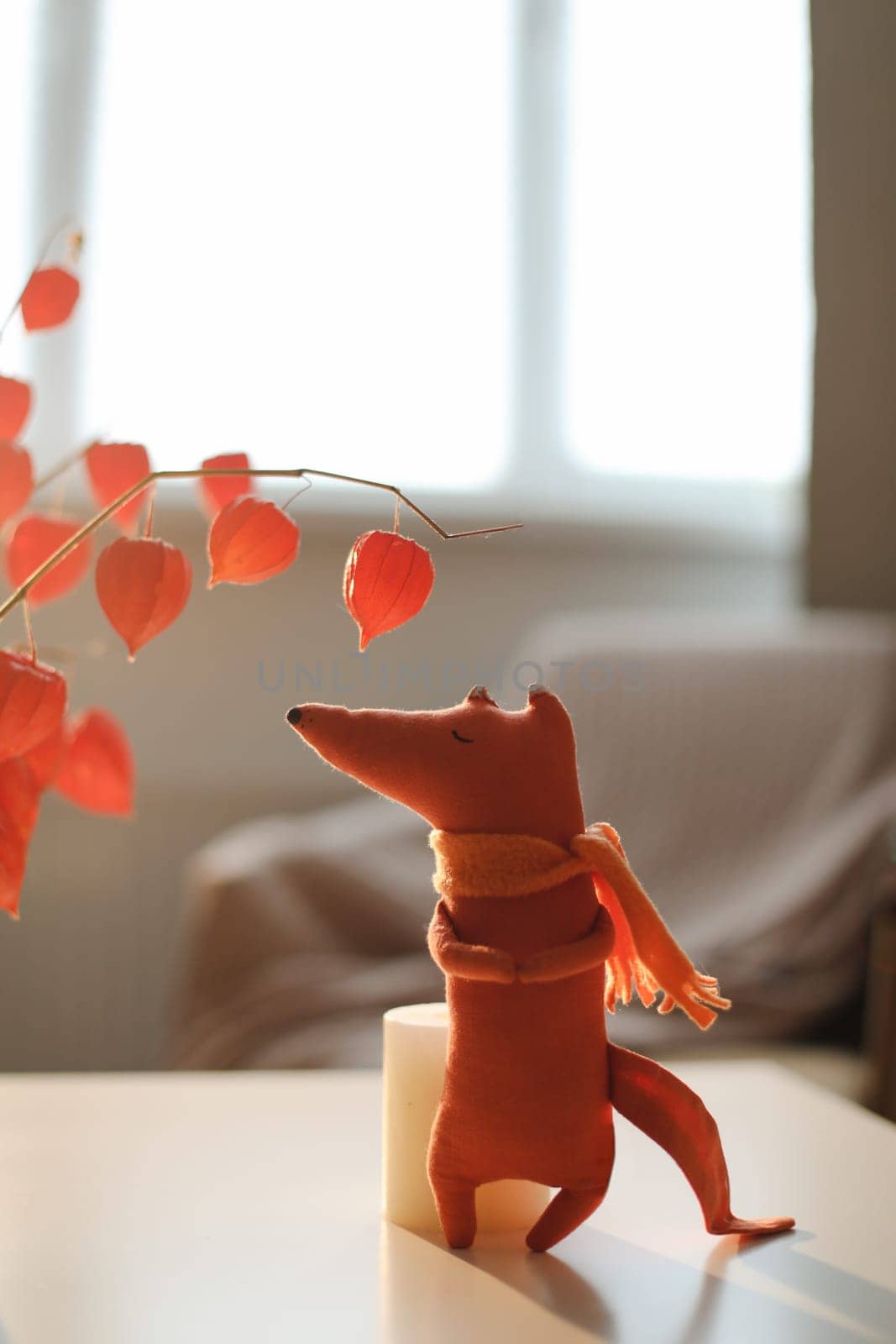 cozy autumn composition with a funny handmade toy fox, fall home decoration