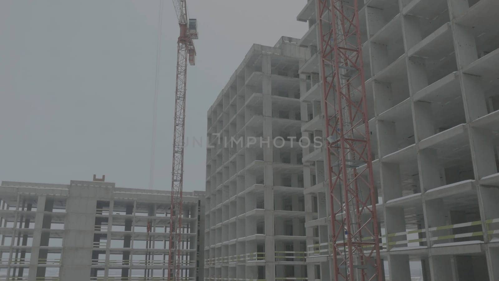 Apartments construction site with crane. Crane and building construction.