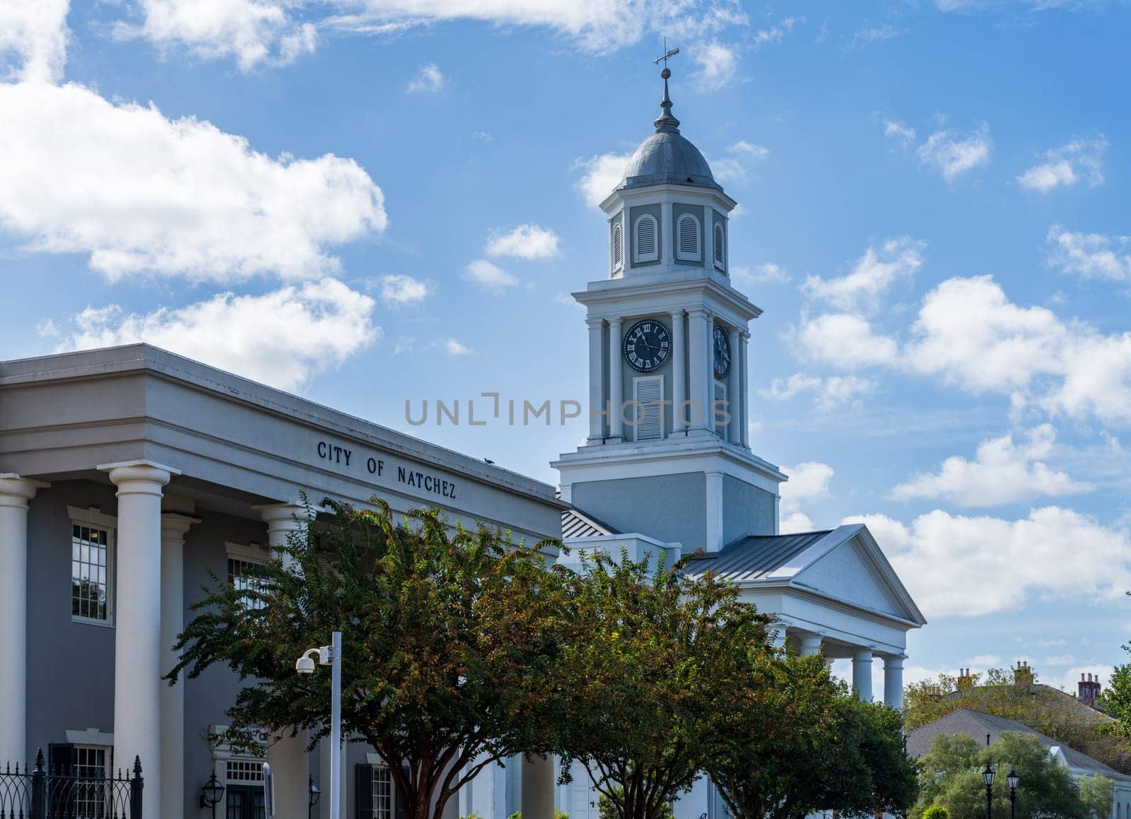 Clock tower of historic First Presbyterian church with the City of Natchez office in Natchez Mississippi