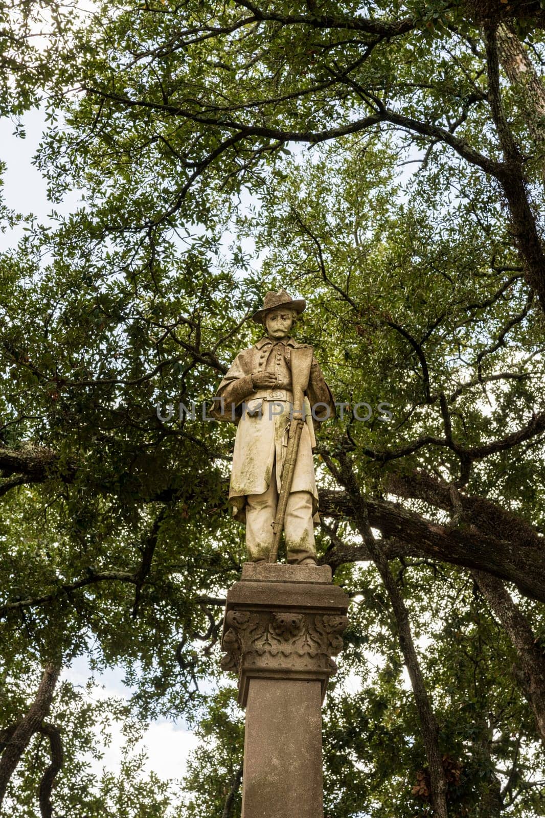 Front view of controversial statue and monument to surrendering conferederate soldier in a park in Natchez, Mississippi