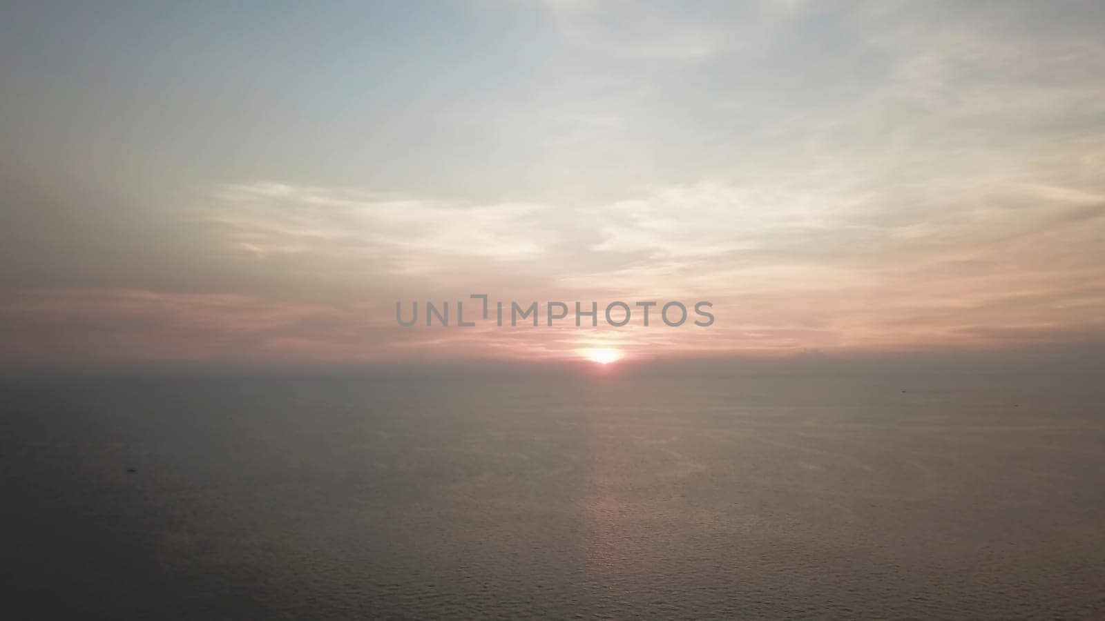 Panorama of beautiful sunset on the ocean. Video. View of sunset seascape in the middle of the ocean. Aerial.