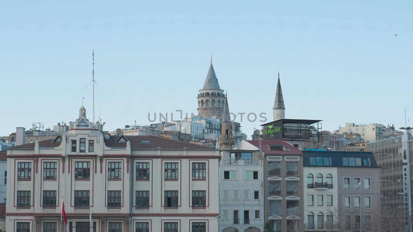 Galata Tower on background of city. Action. Ancient tower towers over center of Istanbul. Galata Tower is popular tourist attraction in Istanbul.