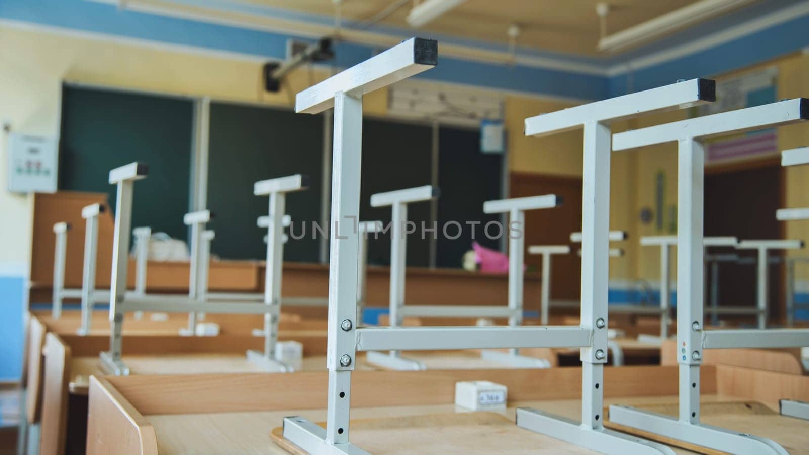 The concept of graduating from high school. Upside-down chairs in an empty classroom at the school