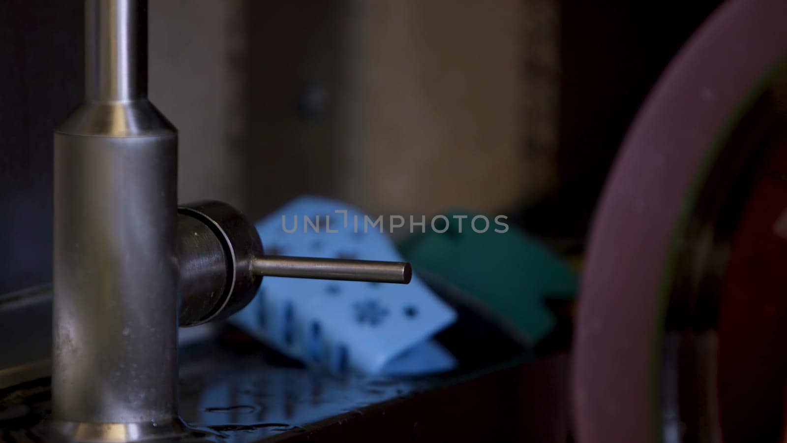 Hand opening a stainless steel water faucet with no water. Close up of female hand opening and closing broken tap at the kitchen at home.