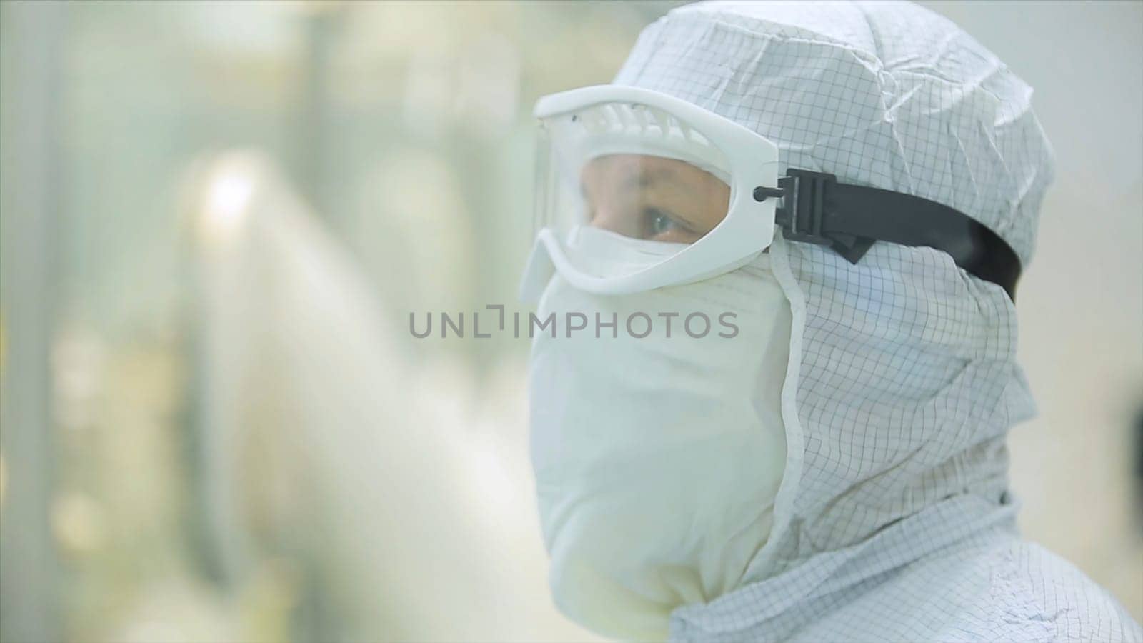Worker in apron, cap, gloves with tablet checking process at production line in factory. Quality Control Workers Examining Pills in Lab. Pharmaceutical lab technicians inspecting the quality of medical pills.