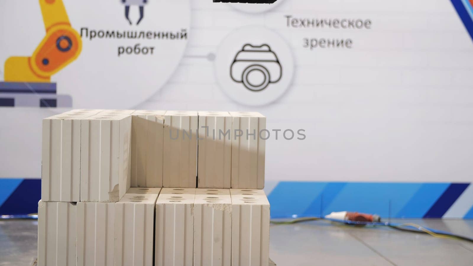 Automatics bricklayer robot exhibit showing its opportunities. Concept of robotic technologies in construction industry, building a wall the help of automated robot.