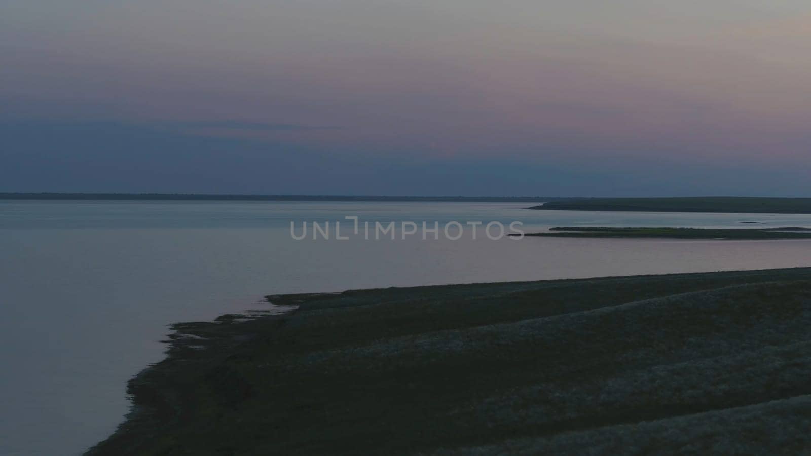 Aerial view of beautiful emerald green water lake and summer landscape sunset. Sunset on the lake.