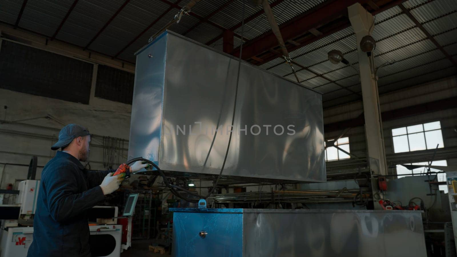 View inside of factory workshop with crane transporting metal detail. Creative. Worker operator managing metal construction transportation