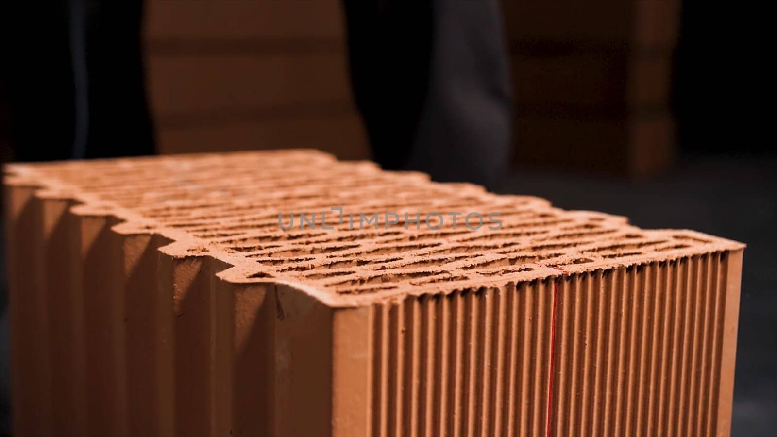 Building a house from a red ceramic block. Block masonry, incomplete red brick corner at the construction site.