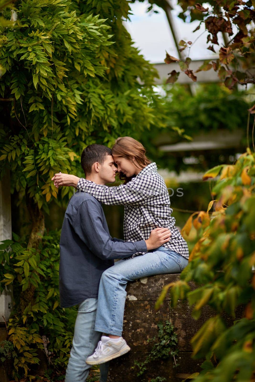 Young Cute Female Hugs Boyfriend. In Autumn Outdoor. Lovers Walking in Park. Attractive Funny Couple. Lovestory in Forest. Man and Woman. Cute Lovers in the Park. Family Concept. Happy Couple. by Andrii_Ko