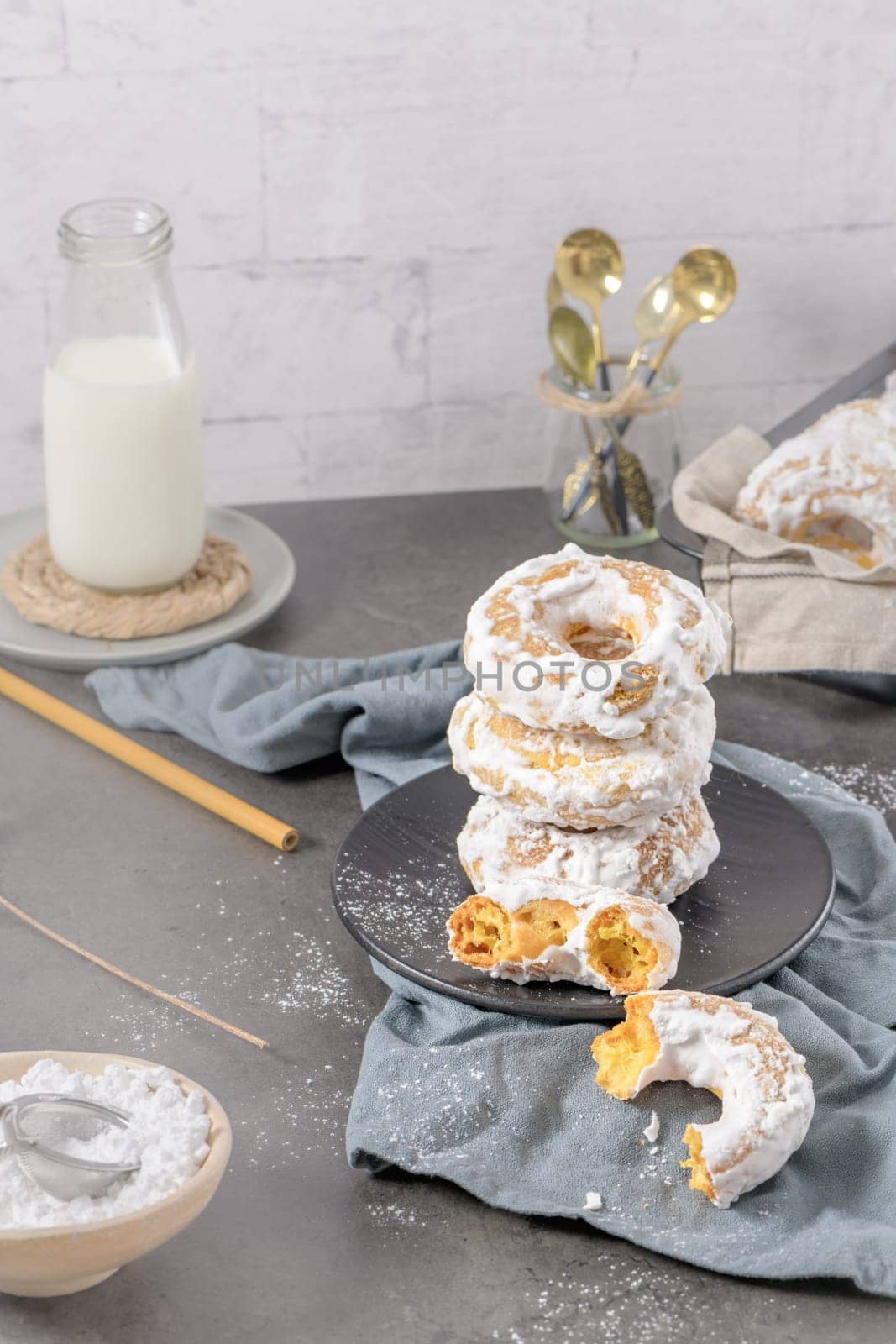 Sweet portuguese donuts with white glaze. Donuts baked at home. Simple and tasty dessert.