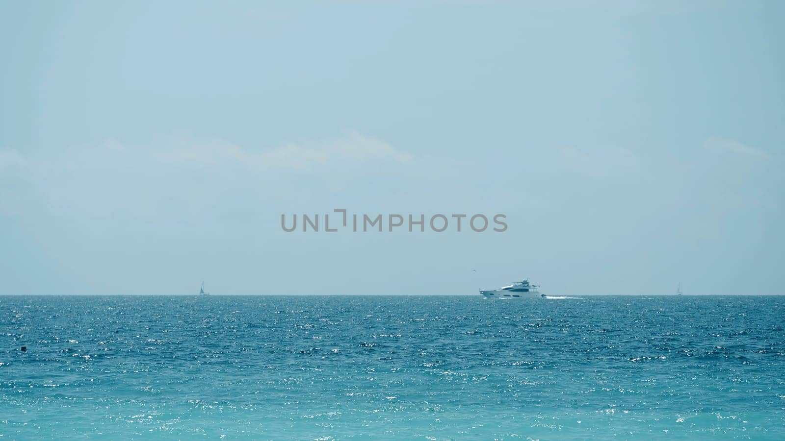 Beautiful calm sea and blue cloudy sky. Action. Amazing horizon and the endless sea water