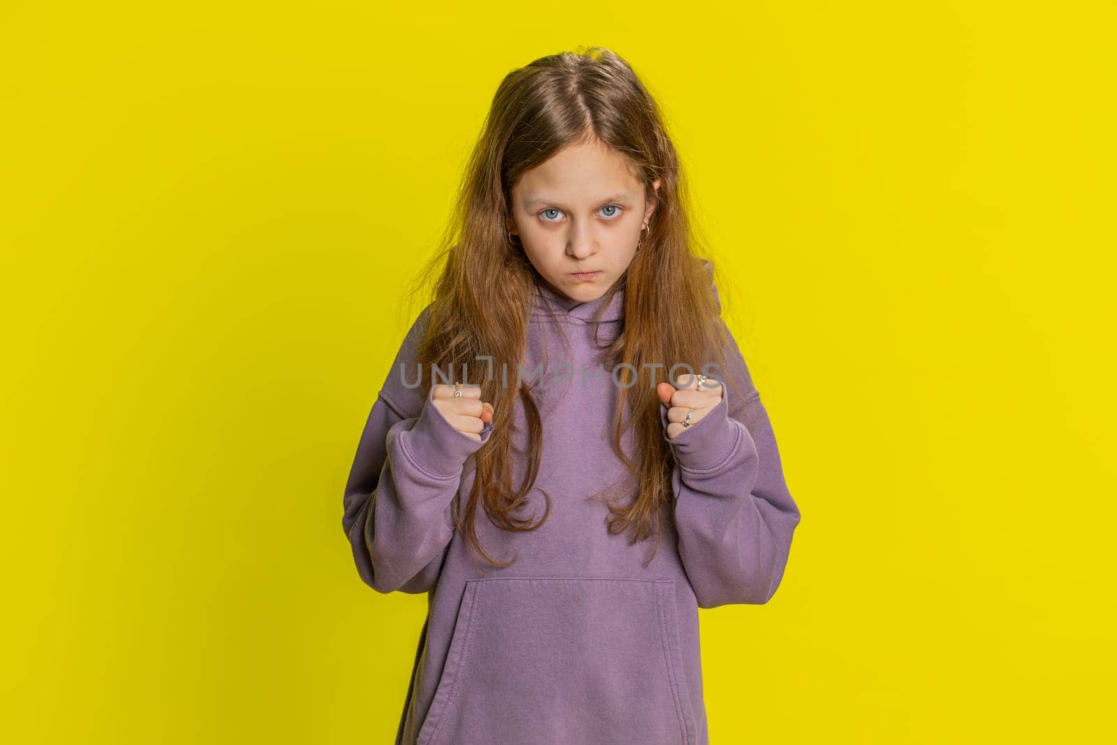 Dissatisfied young preteen child girl kid expressing disbelief irritation, feeling bored nervous, disappointed in result, bad news, fail, lose game. Teenager children isolated on yellow background