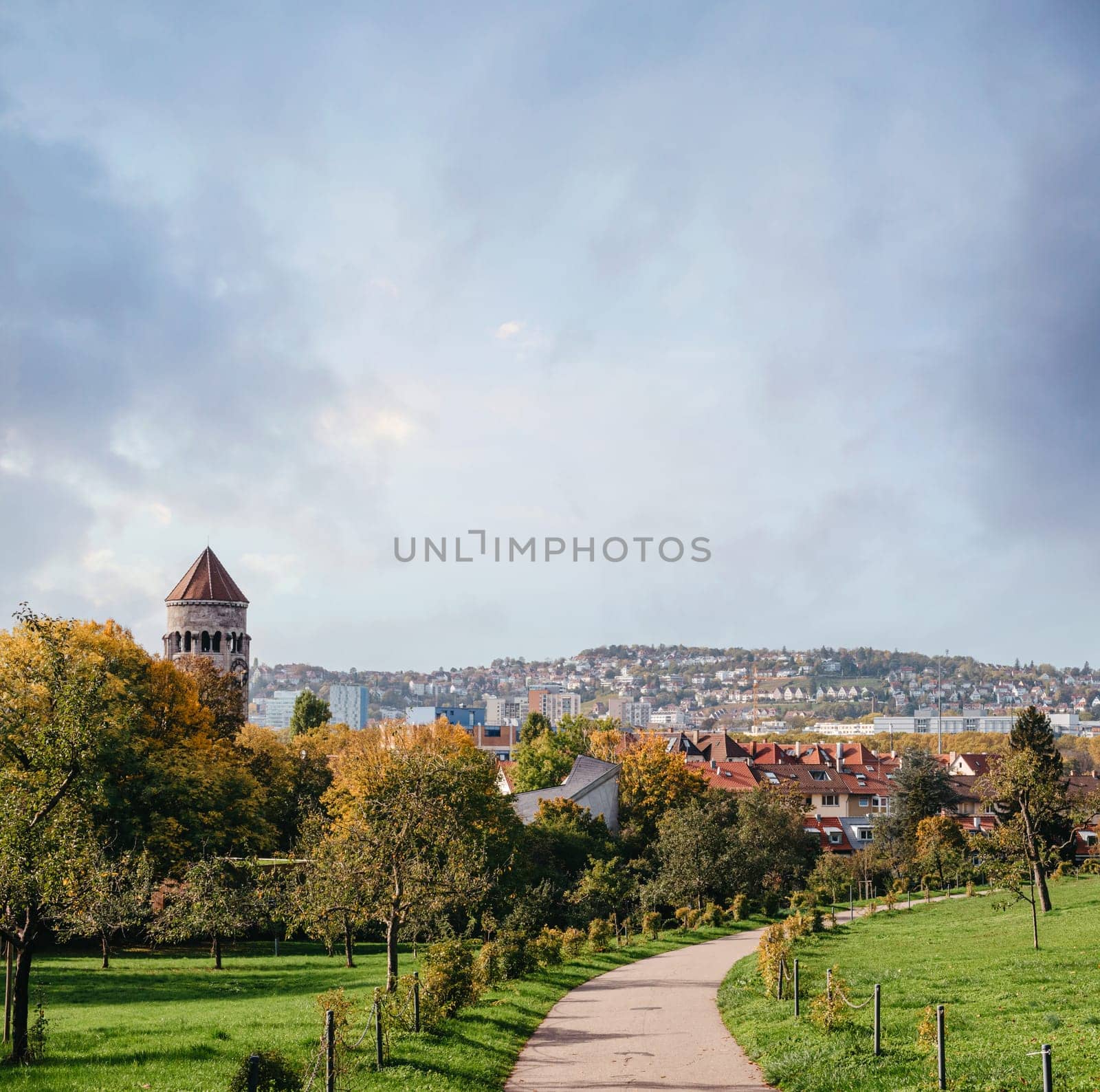 Germany, Stuttgart panorama view. Beautiful houses in autumn, Sky and nature landscape. Vineyards in Stuttgart - colorful wine growing region in the south of Germany with view over Neckar Valley. Germany, Stuttgart city panorama view above vineyards, industry, houses, streets, stadium and highway at sunset in warm orange light.