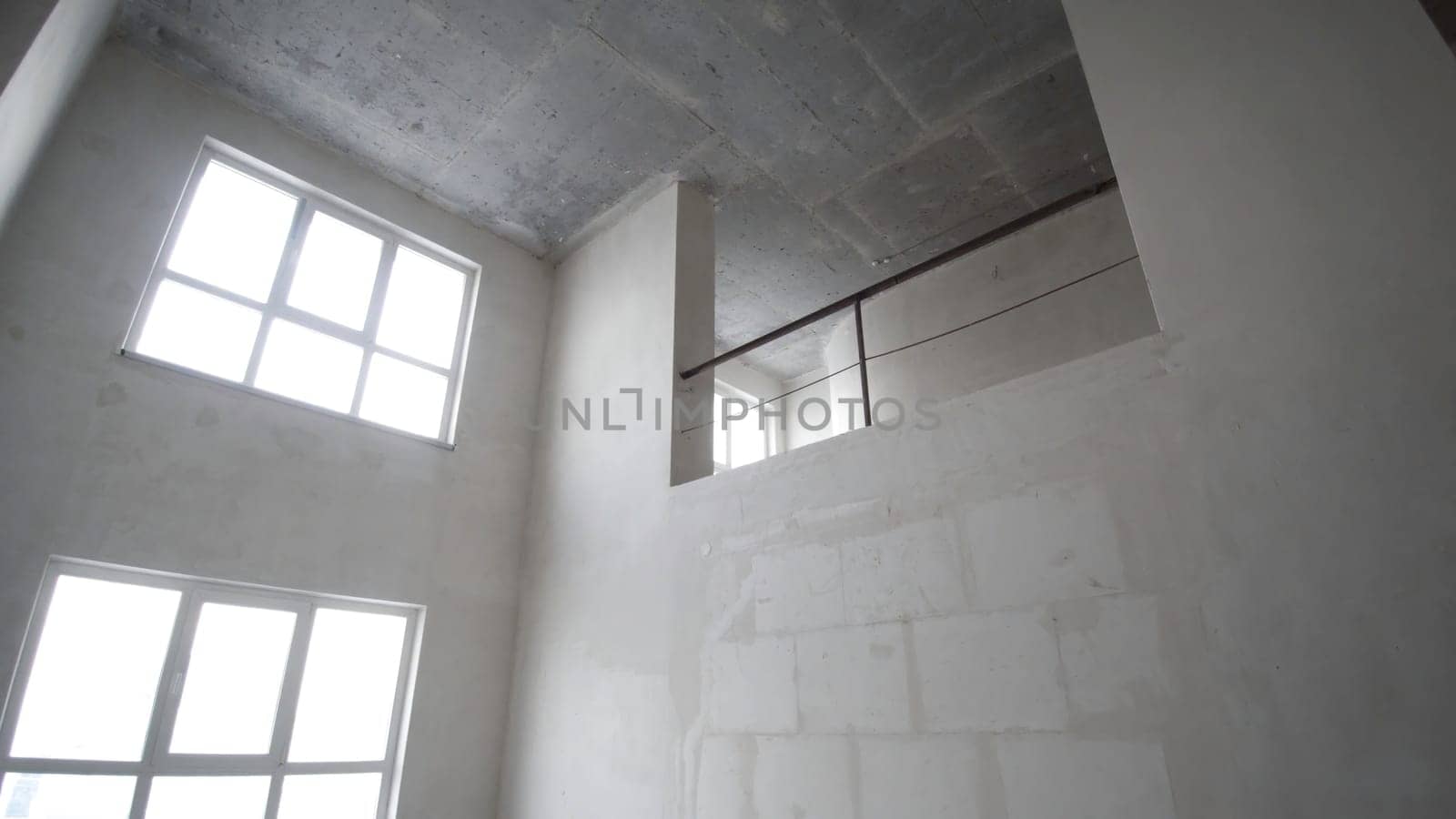 Renovation interior. Clip. Blank white wall with window and concrete floor