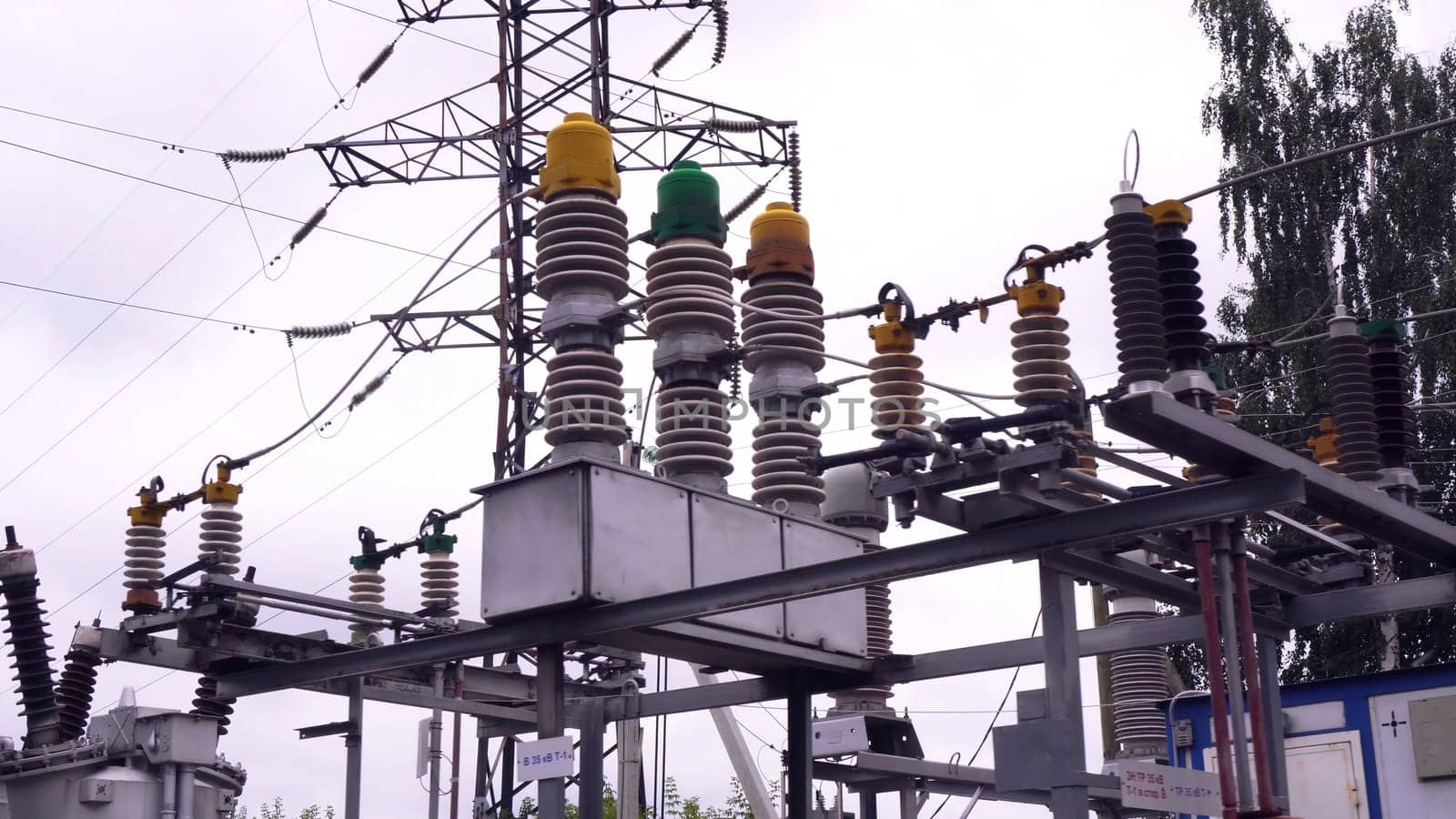 Power lines and electric poles. Frame. High-voltage lines against background of electrical distribution stations.