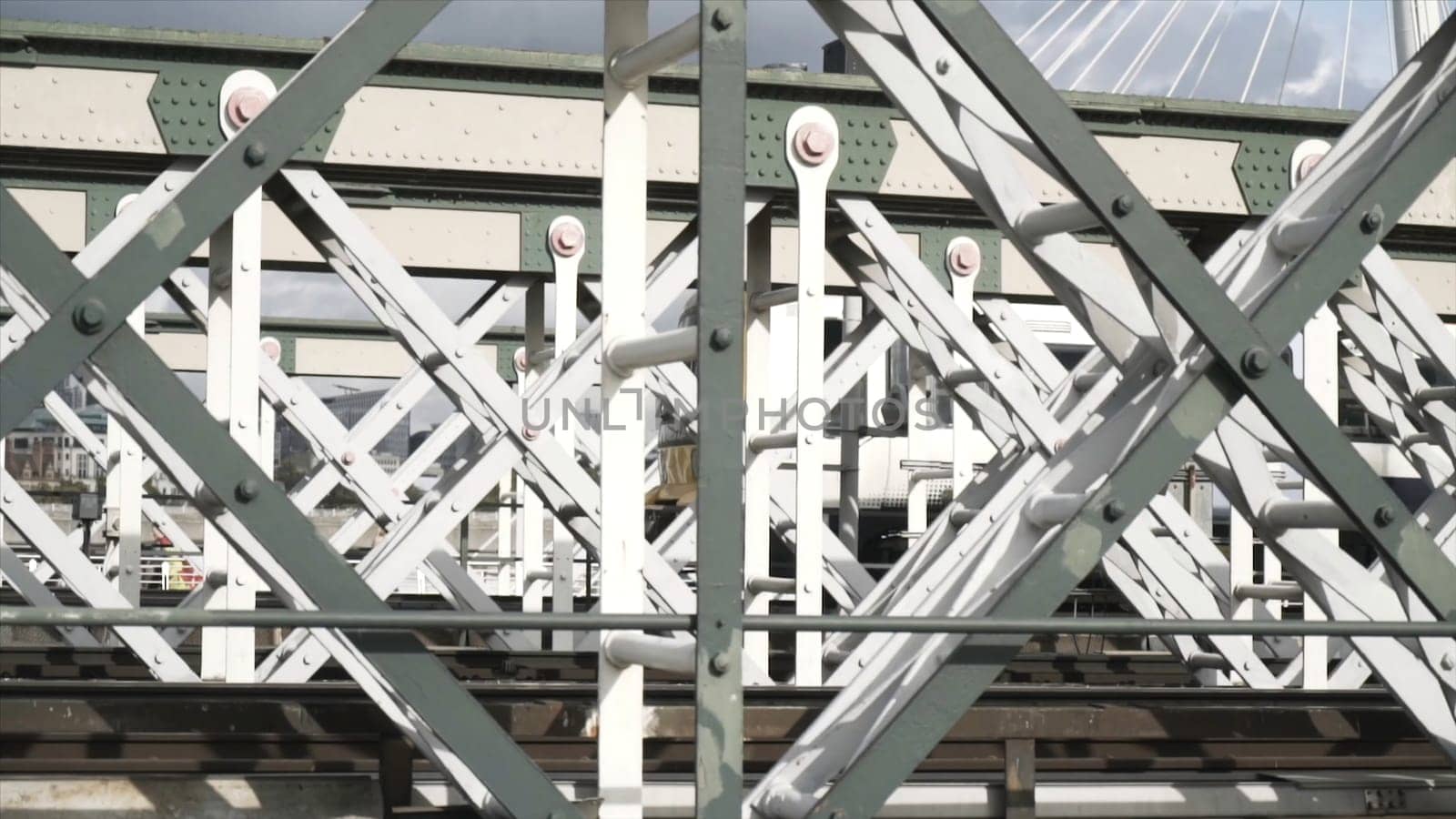 Close-up view of the white wagon going rapidly on the bridge against the blue sky. Urban rail transport